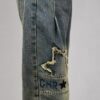 spodnie jeansowe STAR Denim z aplikacjami luźne spodnie jeansowe z gumką w pasie spodnie denim z gwiazdkami i przetarciami damskie spodnie jeansowe z dekoracyjną nogawką spodnie jeansowe z dekatyzowanym wykończeniem modne spodnie denim z nadrukiem na nogawce spodnie jeansowe o swobodnym fasonie spodnie STAR Denim Butik Madzia Fashion